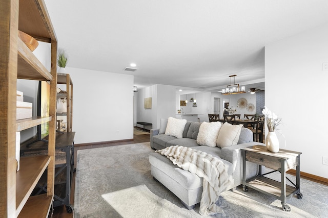 living room featuring an inviting chandelier and hardwood / wood-style flooring