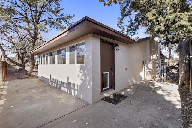 view of property exterior with a patio area