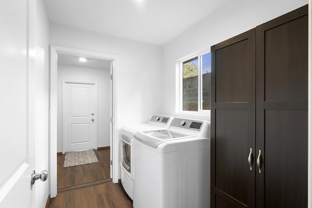 washroom with washer and clothes dryer and dark hardwood / wood-style floors