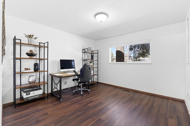 office with dark hardwood / wood-style floors and a textured ceiling