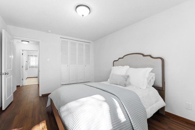 bedroom with dark hardwood / wood-style floors and a closet