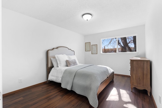 bedroom featuring dark hardwood / wood-style floors and a textured ceiling