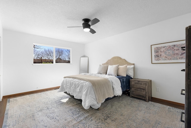 bedroom with a textured ceiling and ceiling fan