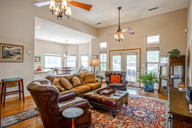 hall featuring a towering ceiling and light tile patterned floors