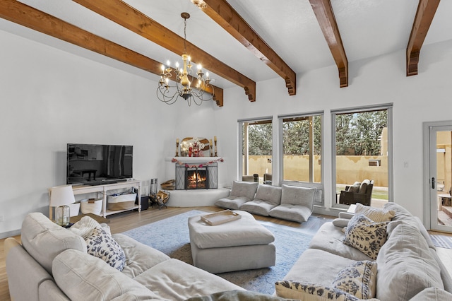 living room with an inviting chandelier, hardwood / wood-style floors, and beamed ceiling