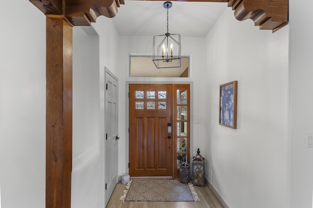 entryway featuring an inviting chandelier and light wood-type flooring