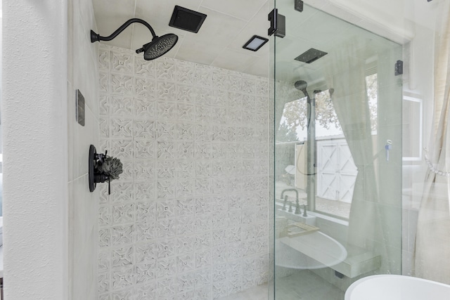 bathroom featuring a shower with shower door