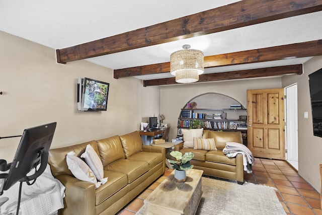 tiled living room with an inviting chandelier and beam ceiling