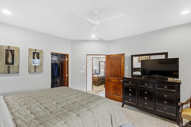 bedroom featuring a walk in closet, connected bathroom, ceiling fan, and a closet