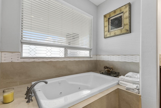 bathroom featuring tiled tub