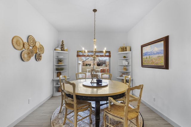 dining area featuring a chandelier and light hardwood / wood-style flooring