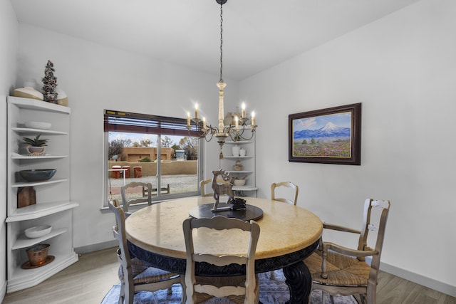 dining room featuring wood-type flooring and a notable chandelier