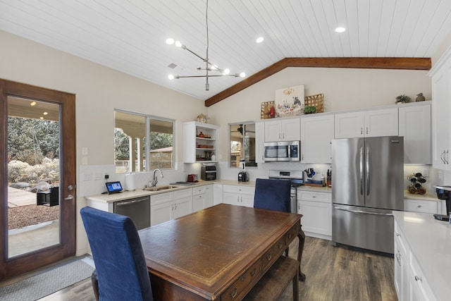 kitchen featuring tasteful backsplash, white cabinets, appliances with stainless steel finishes, and wooden ceiling