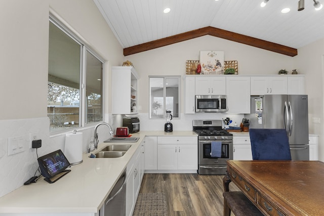 kitchen featuring sink, wood ceiling, appliances with stainless steel finishes, lofted ceiling with beams, and white cabinets