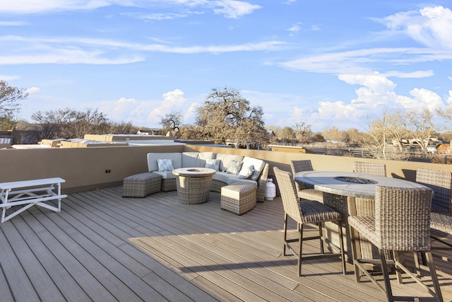 wooden deck with an outdoor living space with a fire pit