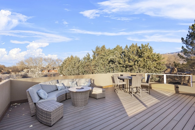 deck with an outdoor living space with a fire pit