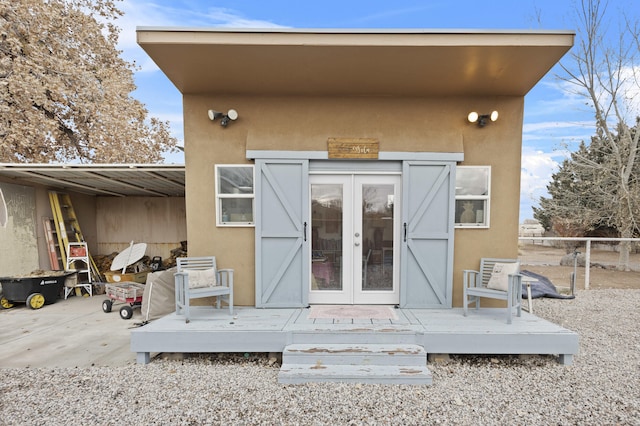 back of house with a wooden deck and french doors