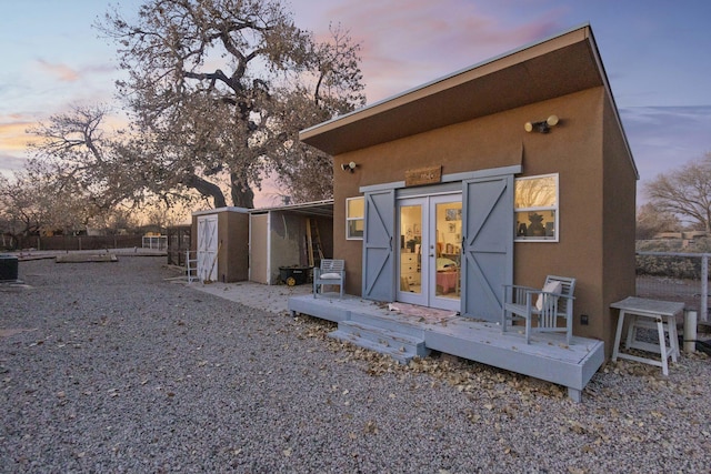 back house at dusk featuring central AC unit