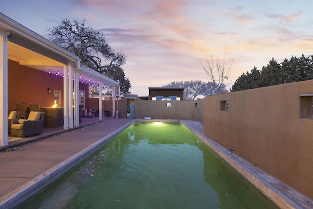 view of pool at dusk