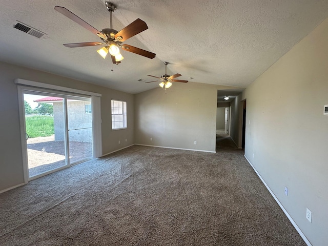 carpeted spare room with lofted ceiling and a textured ceiling