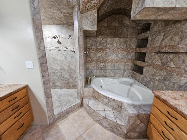 full bathroom featuring a tub with jets, a shower stall, vanity, and tile patterned floors