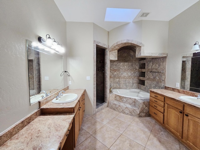 bathroom featuring a garden tub, a sink, visible vents, and a skylight