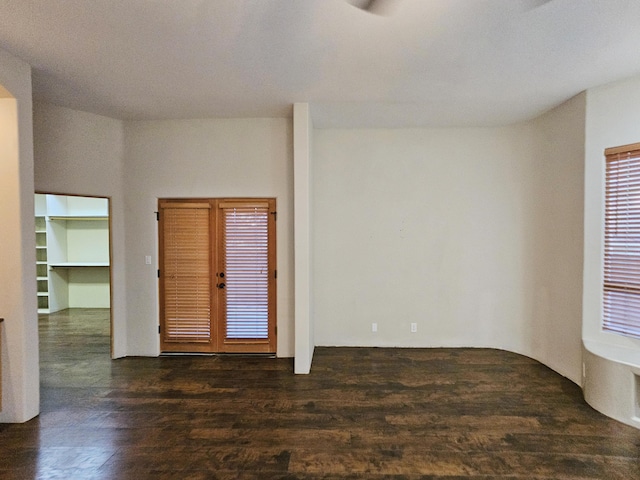 spare room featuring dark wood finished floors