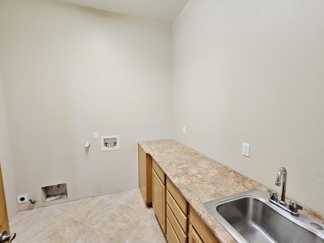 laundry room with a sink, light tile patterned flooring, gas dryer hookup, hookup for a washing machine, and cabinet space