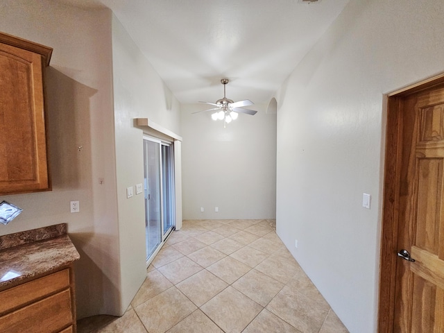 empty room featuring ceiling fan and light tile patterned floors