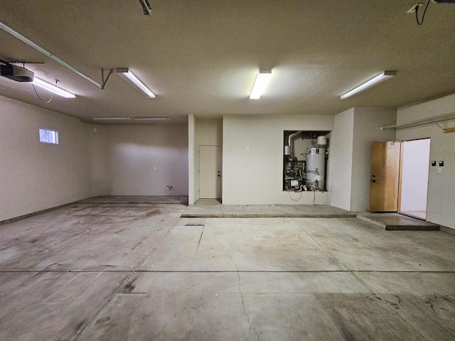 garage featuring gas water heater and a garage door opener