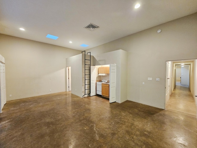 unfurnished living room with concrete flooring