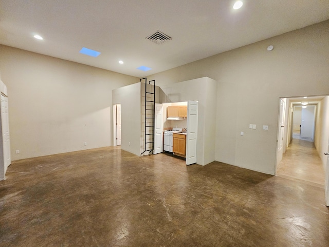 unfurnished living room with a high ceiling