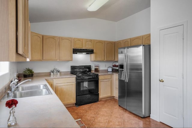 kitchen featuring stainless steel refrigerator with ice dispenser, light brown cabinetry, sink, gas stove, and vaulted ceiling