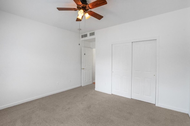 unfurnished bedroom featuring carpet floors, ceiling fan, and a closet