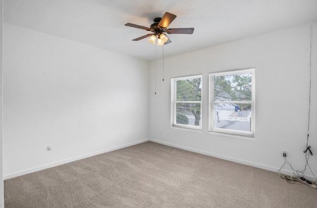 empty room featuring ceiling fan and carpet flooring