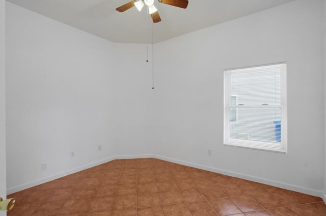 empty room with ceiling fan and light tile patterned flooring