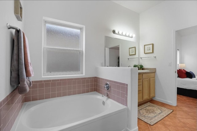 bathroom featuring vanity, tile patterned floors, and a tub