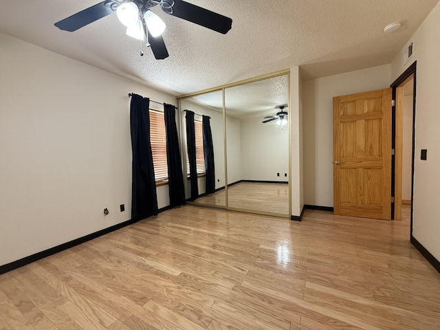 3839 Montgomery NE Unit 703, Albuquerque, NM 87109 - unfurnished room featuring a ceiling fan, a textured ceiling, light wood finished floors, and baseboards