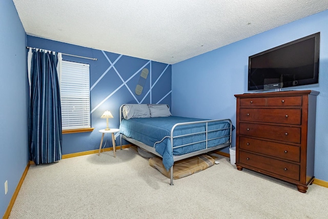 carpeted bedroom featuring a textured ceiling