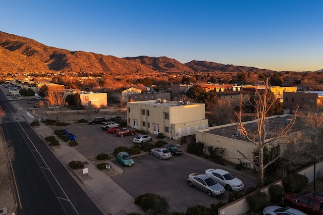 aerial view at dusk featuring a mountain view