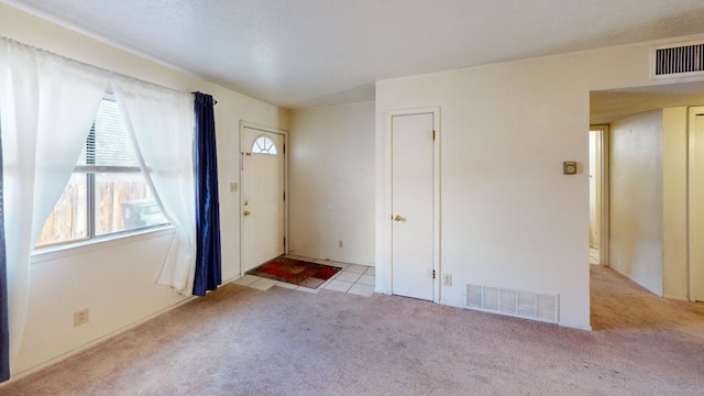 entrance foyer featuring light carpet