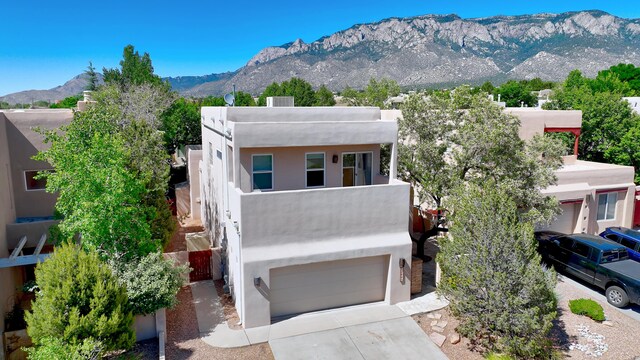 view of front of home with a garage and a mountain view