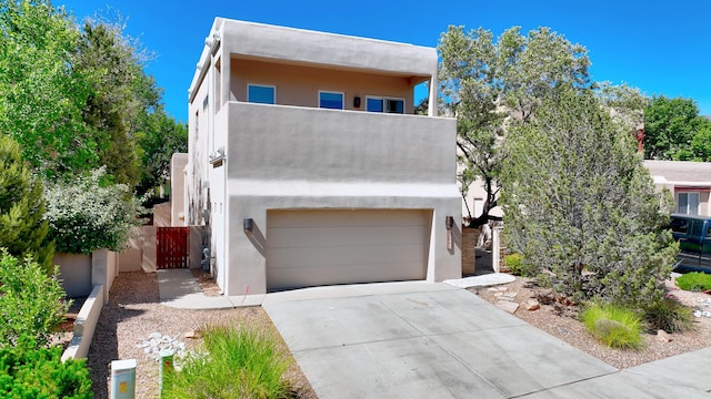 pueblo-style house featuring a garage