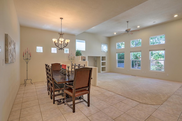 dining area with ceiling fan with notable chandelier and light carpet