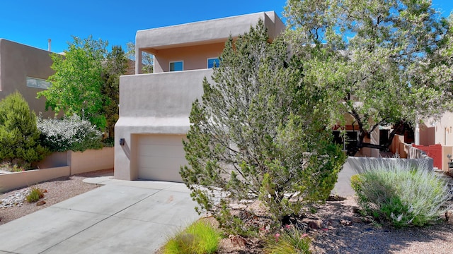 pueblo-style home featuring a garage