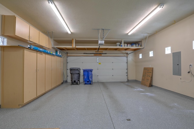 garage featuring a garage door opener and electric panel