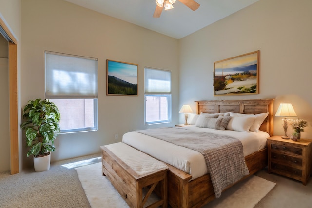 carpeted bedroom with multiple windows and ceiling fan