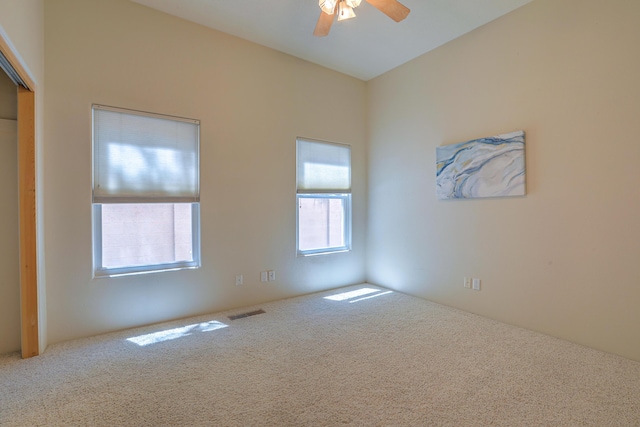 spare room with carpet and ceiling fan