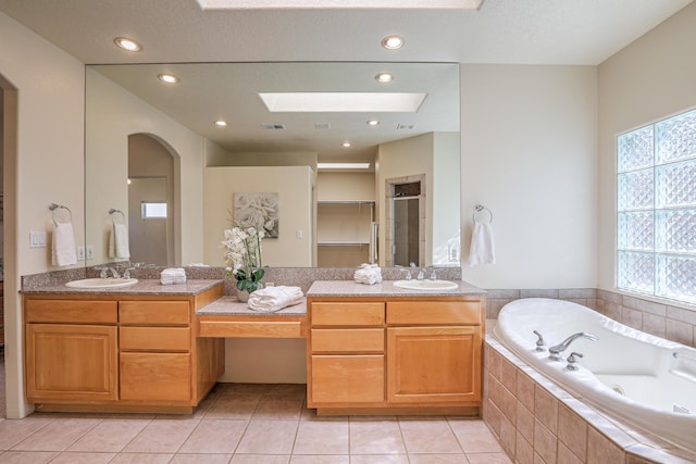 bathroom featuring tile patterned flooring, vanity, and a wealth of natural light