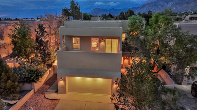 view of front of home with a mountain view and a garage